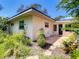 The exterior of the home has a patio area and beautiful landscaping with flowers and plants at 966 N Ronald Reagan Blvd, Longwood, FL 32750