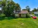 Exterior of the home with a green lawn and beautiful, mature trees at 966 N Ronald Reagan Blvd, Longwood, FL 32750
