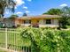 Well-maintained home featuring neutral tones, shuttered windows, and a meticulously manicured lawn at 966 N Ronald Reagan Blvd, Longwood, FL 32750