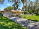 Lovely home featuring an attached garage, verdant lawn and established landscaping at 966 N Ronald Reagan Blvd, Longwood, FL 32750