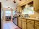 Efficient kitchen with wooden cabinets, good lighting, and practical layout, providing a comfortable cooking experience at 966 N Ronald Reagan Blvd, Longwood, FL 32750