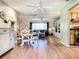 Open-concept living area featuring wood floors, neutral decor, and ceiling fans at 966 N Ronald Reagan Blvd, Longwood, FL 32750