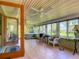 Bright sunroom with tile flooring, multiple windows overlooking the yard, and comfortable wicker seating at 966 N Ronald Reagan Blvd, Longwood, FL 32750