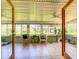 Enclosed sunroom featuring tiled floor, wicker seating, ceiling fans, and abundant natural light at 966 N Ronald Reagan Blvd, Longwood, FL 32750