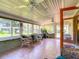 Inviting sunroom features tile floors, multiple windows, and wicker seating for relaxing and enjoying the view at 966 N Ronald Reagan Blvd, Longwood, FL 32750