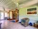 Bright and airy sunroom features tile flooring, multiple windows, and comfortable wicker seating at 966 N Ronald Reagan Blvd, Longwood, FL 32750