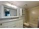 Modern bathroom featuring a vanity with a stone countertop and a tiled shower/tub combo at 501 W Old Us Highway 441 # C201, Mount Dora, FL 32757