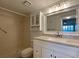 Bright bathroom featuring a white vanity with a stone countertop and a shower with a glass door at 501 W Old Us Highway 441 # C201, Mount Dora, FL 32757