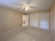Bedroom with neutral carpet, fan, and closet with louvered doors at 501 W Old Us Highway 441 # C201, Mount Dora, FL 32757