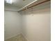 Empty walk-in closet with tile flooring and a wooden clothes rod at 501 W Old Us Highway 441 # C201, Mount Dora, FL 32757