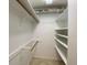 Spacious walk-in closet with multiple shelves, hanging rods and tile flooring at 501 W Old Us Highway 441 # C201, Mount Dora, FL 32757