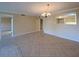Spacious dining area with tile flooring and a pass-through window connecting to the kitchen at 501 W Old Us Highway 441 # C201, Mount Dora, FL 32757