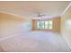 Expansive living room featuring carpeted floors and large windows providing abundant natural light at 501 W Old Us Highway 441 # C201, Mount Dora, FL 32757