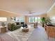 Bright living room with a large window, ceiling fan, and neutral decor at 501 W Old Us Highway 441 # C201, Mount Dora, FL 32757