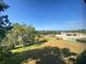 Serene view from the property, showcasing a lawn, trees, the lake, and a pool at 501 W Old Us Highway 441 # C201, Mount Dora, FL 32757