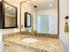 Bathroom with granite countertop, updated vanity, and large mirror at 155 S Court Ave # 2107, Orlando, FL 32801