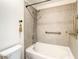 Bathroom features a shower/tub combo and neutral tile at 155 S Court Ave # 2107, Orlando, FL 32801