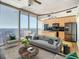 Modern living room with city view, hardwood floors, and stylish furniture at 155 S Court Ave # 2107, Orlando, FL 32801