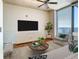 Spacious living room featuring hardwood floors and large windows at 155 S Court Ave # 2107, Orlando, FL 32801