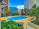 Inviting community pool with surrounding lounge chairs at 155 S Court Ave # 2107, Orlando, FL 32801