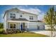 Two-story house with gray siding, stone accents, and a two-car garage at 14 Weston Rd, Leesburg, FL 34748