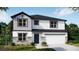 Two-story home with stone accents, white siding and a two car garage at 111 Addle Hill Ct, Deland, FL 32720