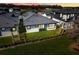 Home's backyard at night with grassy area and hedge at 3016 Kensington Ave, Davenport, FL 33837