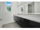 Modern bathroom with sleek dark vanity and large mirror at 3016 Kensington Ave, Davenport, FL 33837