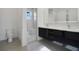 Modern bathroom with double vanity, walk-in shower, and toilet at 3016 Kensington Ave, Davenport, FL 33837