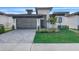 Modern home with gray garage door and landscaped yard at 3016 Kensington Ave, Davenport, FL 33837