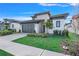 Modern home with gray and stone exterior, two-car garage, and landscaped lawn at 3016 Kensington Ave, Davenport, FL 33837