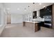 Modern kitchen with black cabinets, wood island, and pendant lighting at 3016 Kensington Ave, Davenport, FL 33837