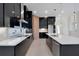 Modern kitchen with black cabinets, wood island, and pendant lighting at 3016 Kensington Ave, Davenport, FL 33837