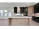 Modern kitchen with black cabinets, wood island, and pendant lighting at 3016 Kensington Ave, Davenport, FL 33837