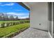 Private patio with view of grassy backyard and trees at 3016 Kensington Ave, Davenport, FL 33837