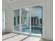 View of a refreshing pool through sliding glass doors at 3016 Kensington Ave, Davenport, FL 33837