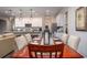 Dining room features a wood table and chairs with views into the living room and kitchen at 2231 Elegant Manor Cir, Edgewater, FL 32141