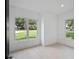 Bright bedroom featuring large windows with neighborhood views, hardwood floors, and white walls at 260 Deer Isle Dr, Winter Garden, FL 34787