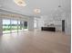 Spacious living room leads into kitchen, features light wood floors, large windows, and modern recessed lighting at 260 Deer Isle Dr, Winter Garden, FL 34787
