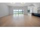 Bright living room boasts a wall of windows offering expansive waterfront views and light hardwood flooring at 260 Deer Isle Dr, Winter Garden, FL 34787
