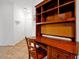 Home office with wooden desk and built-in shelving at 904 Charo Pkwy # 518, Davenport, FL 33897