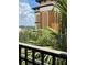 Balcony view showcasing the building's exterior and lush green landscape beyond the railing at 12521 Floridays Resort Dr # 302F, Orlando, FL 32821