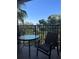Relaxing balcony features a table, chair, and scenic views of lush greenery at 12521 Floridays Resort Dr # 302F, Orlando, FL 32821