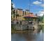 Picturesque gazebo situated on a stone foundation by the water, perfect for relaxing outdoors at 12521 Floridays Resort Dr # 302F, Orlando, FL 32821