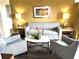 Cozy living room with comfortable seating, stylish decor, and soft lighting for a welcoming ambiance at 12521 Floridays Resort Dr # 302F, Orlando, FL 32821