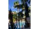 Gathering-friendly pool area with water slides and palm trees at 12521 Floridays Resort Dr # 302F, Orlando, FL 32821