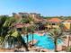 Resort-style pool with surrounding palm trees and lounge chairs creating a relaxing vacation atmosphere at 12521 Floridays Resort Dr # 302F, Orlando, FL 32821