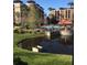 Lush community pool area with palm trees, gazebo, and water feature views; serene resort-style living at 12521 Floridays Resort Dr # 302F, Orlando, FL 32821
