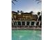Stunning swimming pool area with lounge chairs, tropical plants, and attractive resort landscaping at 12521 Floridays Resort Dr # 302F, Orlando, FL 32821