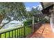 Lakefront balcony with terracotta tile flooring and wrought iron railings at 800 W 2Nd Ave, Windermere, FL 34786